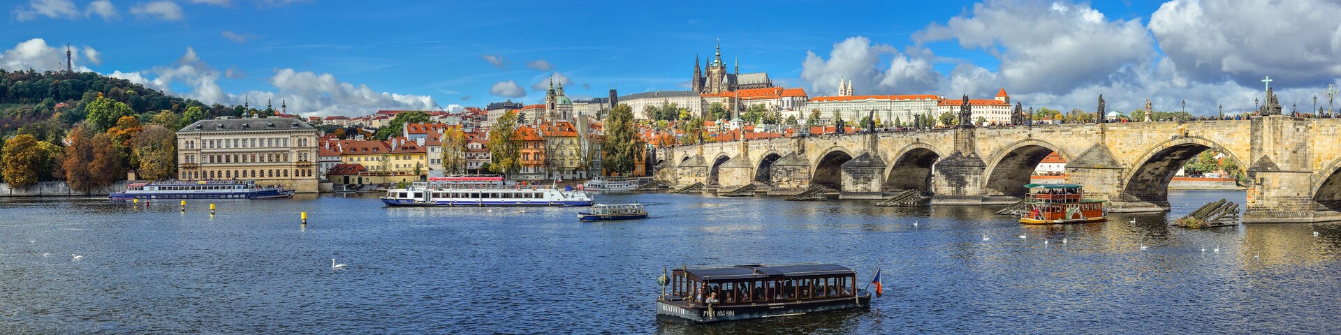 Prague, Czech Republic - October 10, 2017: Beautiful autumn river view on Vltava river, Charles Bridge and Cathedral of Saints Vitus and Prague Castle , Czech Republic. Panorama.