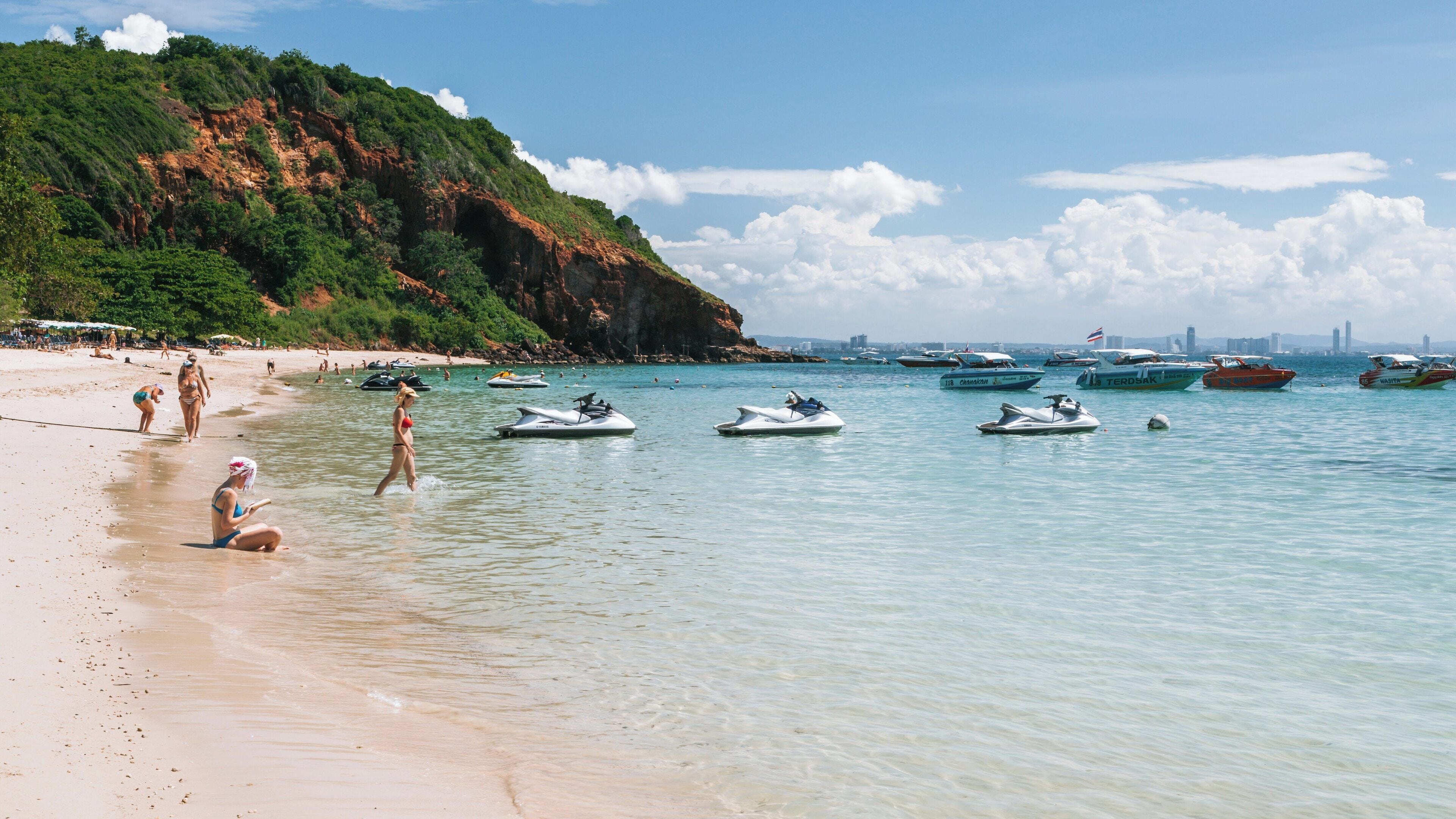 Stunning Nual Beach at Haad Nuan, Koh Lan in Chonburi Province showcases crystal-clear waters and vibrant water activities on a beautiful day