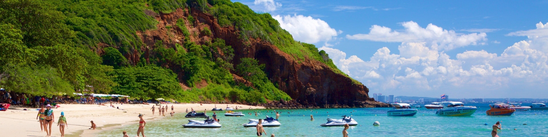 Nual Beach featuring a bay or harbor and swimming as well as a large group of people