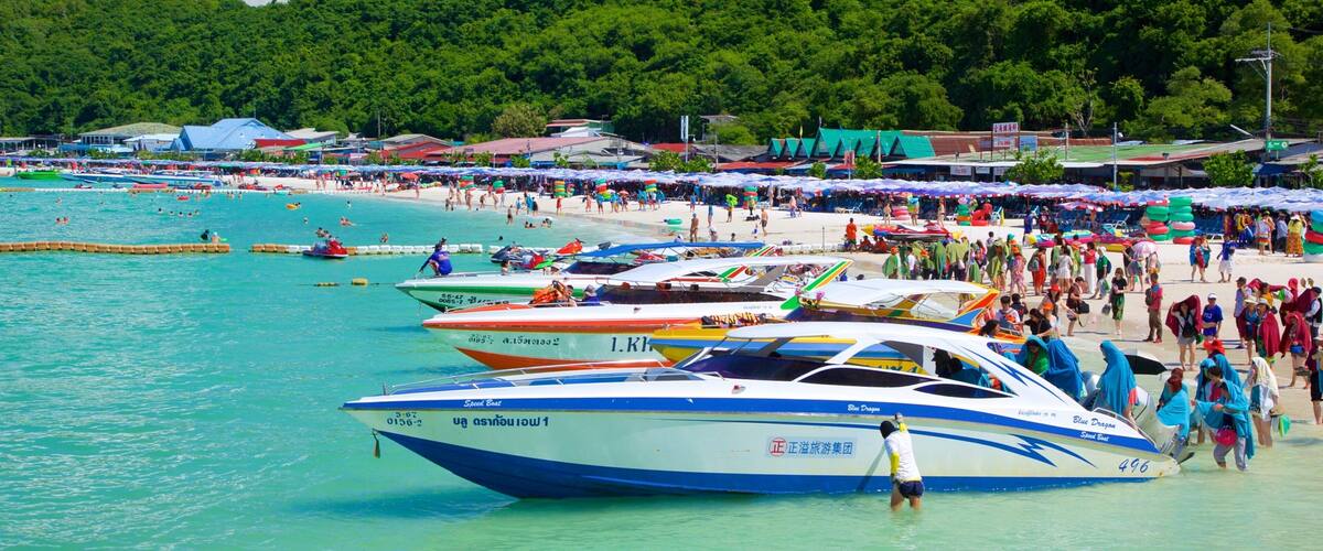 Ta-Yai Beach featuring a sandy beach and boating as well as a large group of people