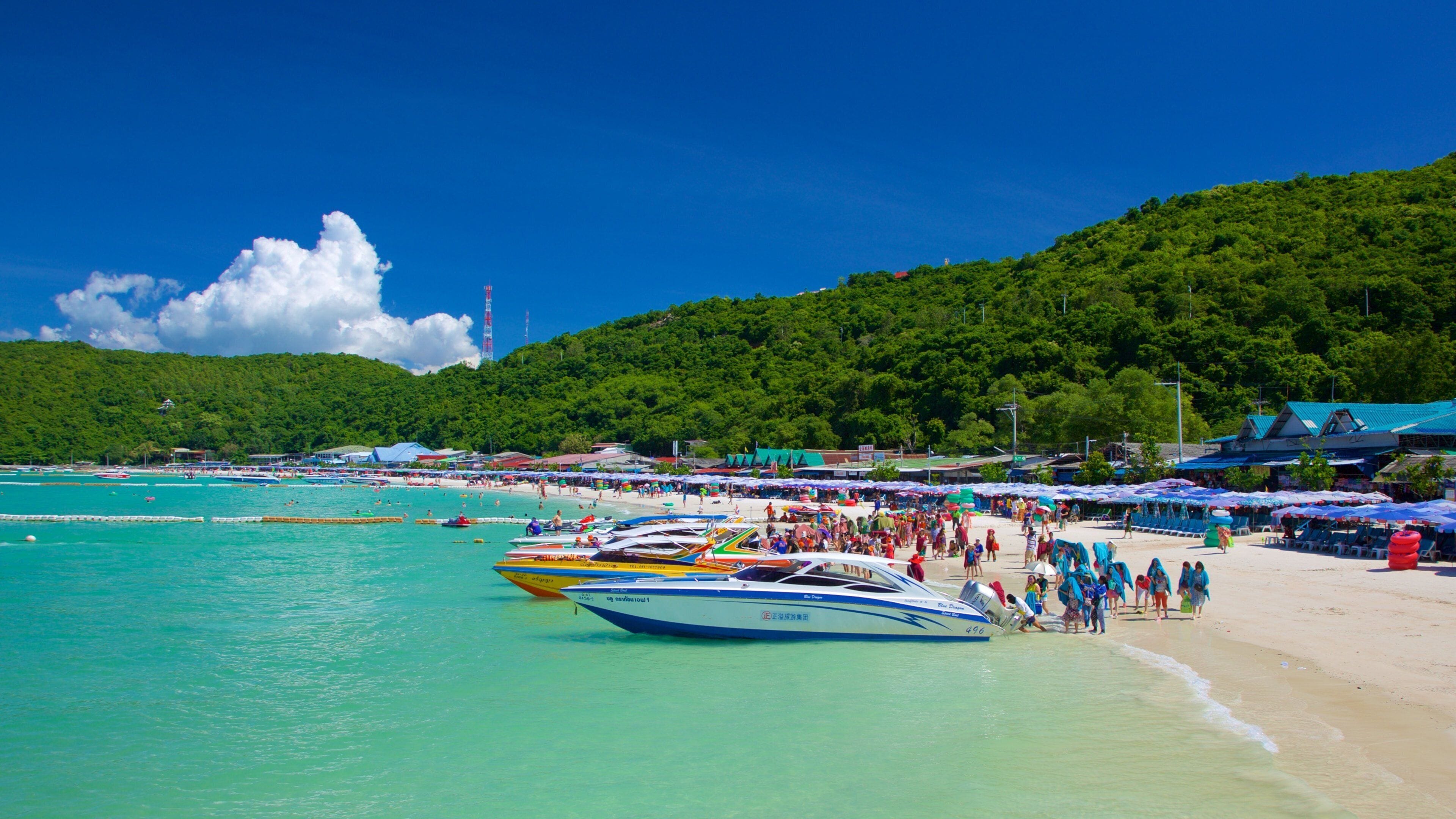 Ta-Yai Beach featuring a sandy beach and boating as well as a large group of people