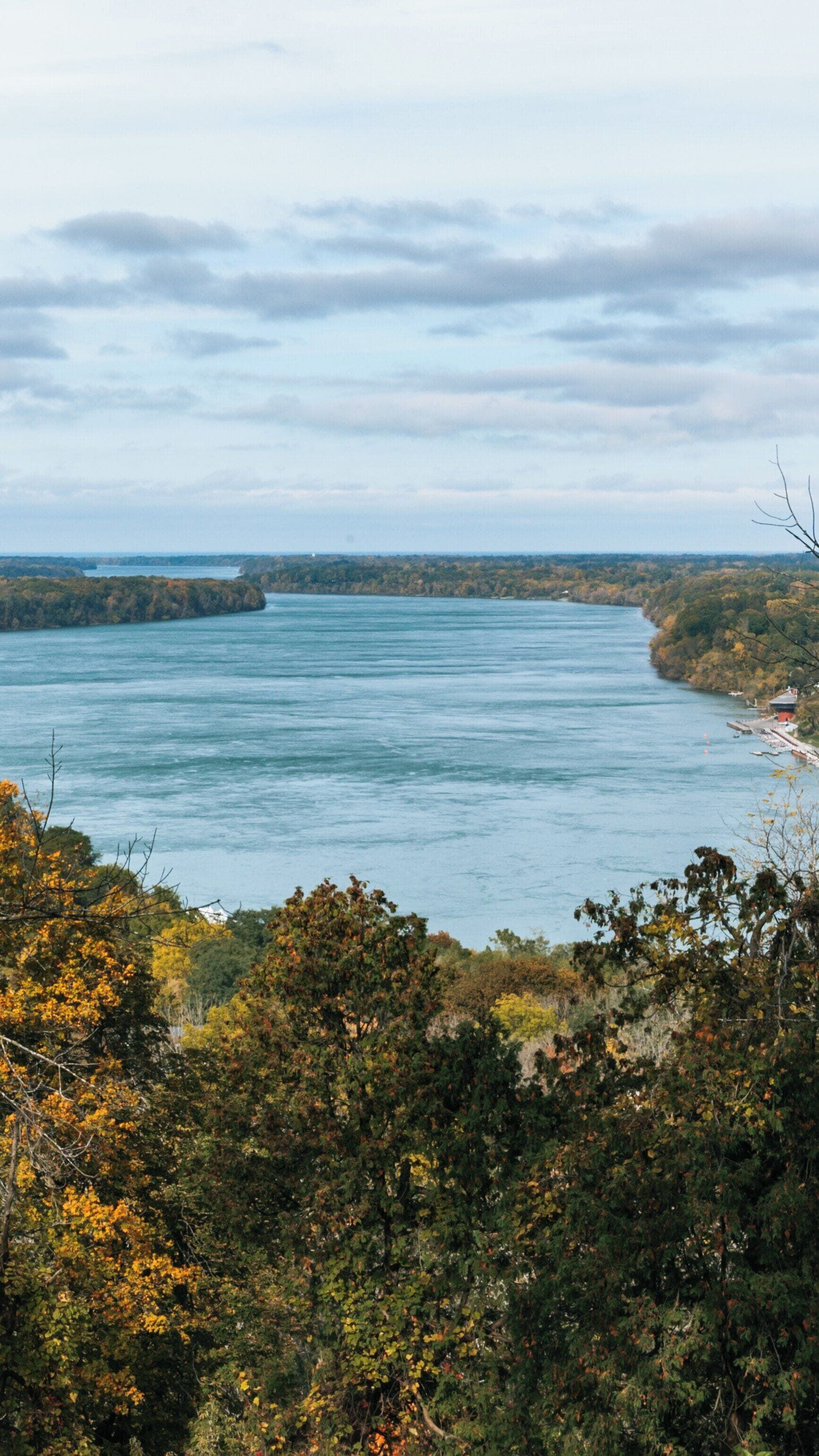 Scenic view of Queenston Heights Park along the Niagara River in Ontario, Canada showcasing autumn colors and tranquil waters