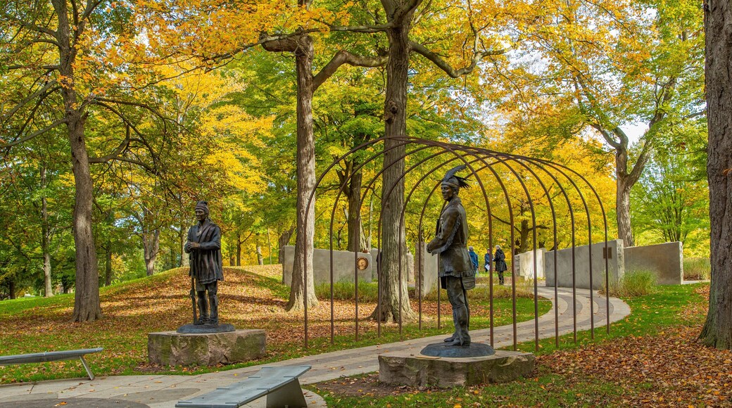 Queenston Heights Park which includes fall colors, a statue or sculpture and a garden