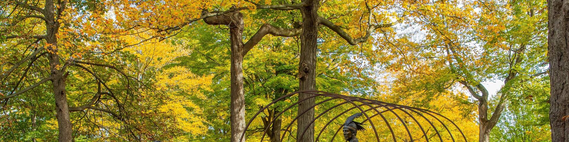 Queenston Heights Park which includes fall colors, a statue or sculpture and a garden