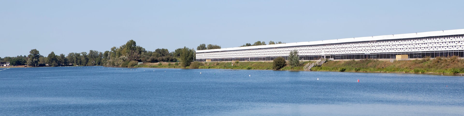 A large body of water with a modern building in the background.