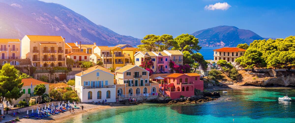 Assos village in Kefalonia, Greece. Turquoise colored bay in Mediterranean sea with beautiful colorful houses in Assos village in Kefalonia, Greece, Ionian island, Cephalonia, Assos village.
