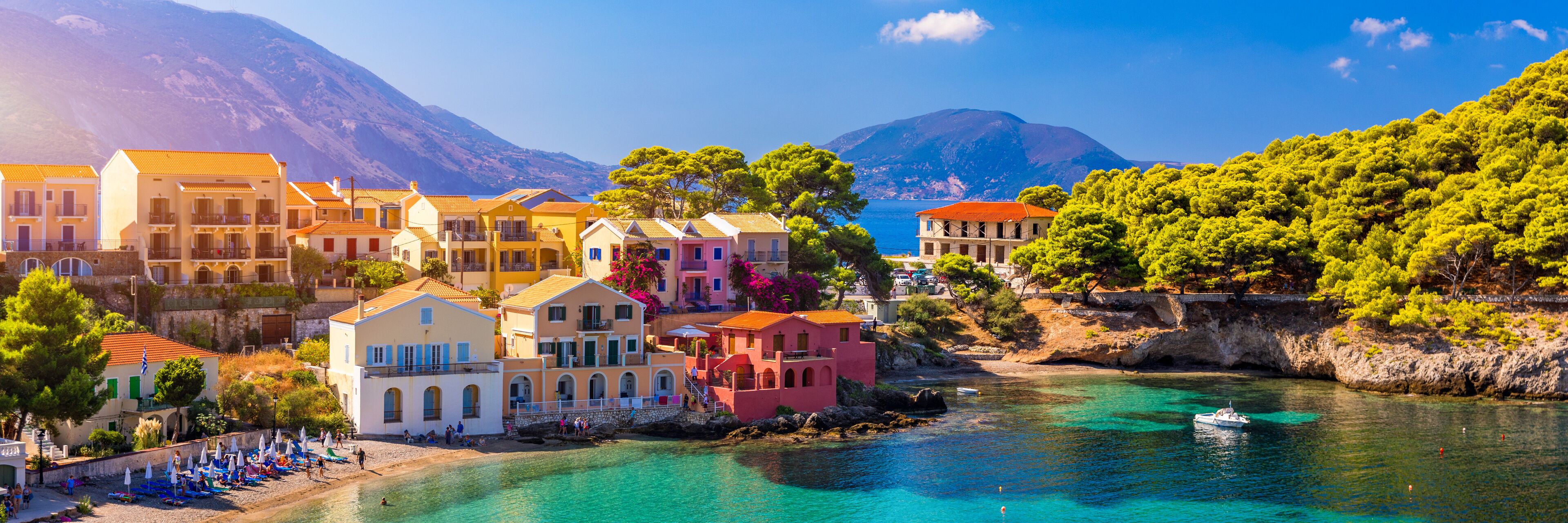 Assos village in Kefalonia, Greece. Turquoise colored bay in Mediterranean sea with beautiful colorful houses in Assos village in Kefalonia, Greece, Ionian island, Cephalonia, Assos village.