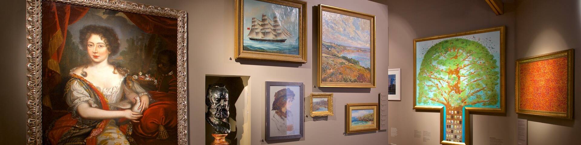 An art gallery with various paintings and sculptures on display.
