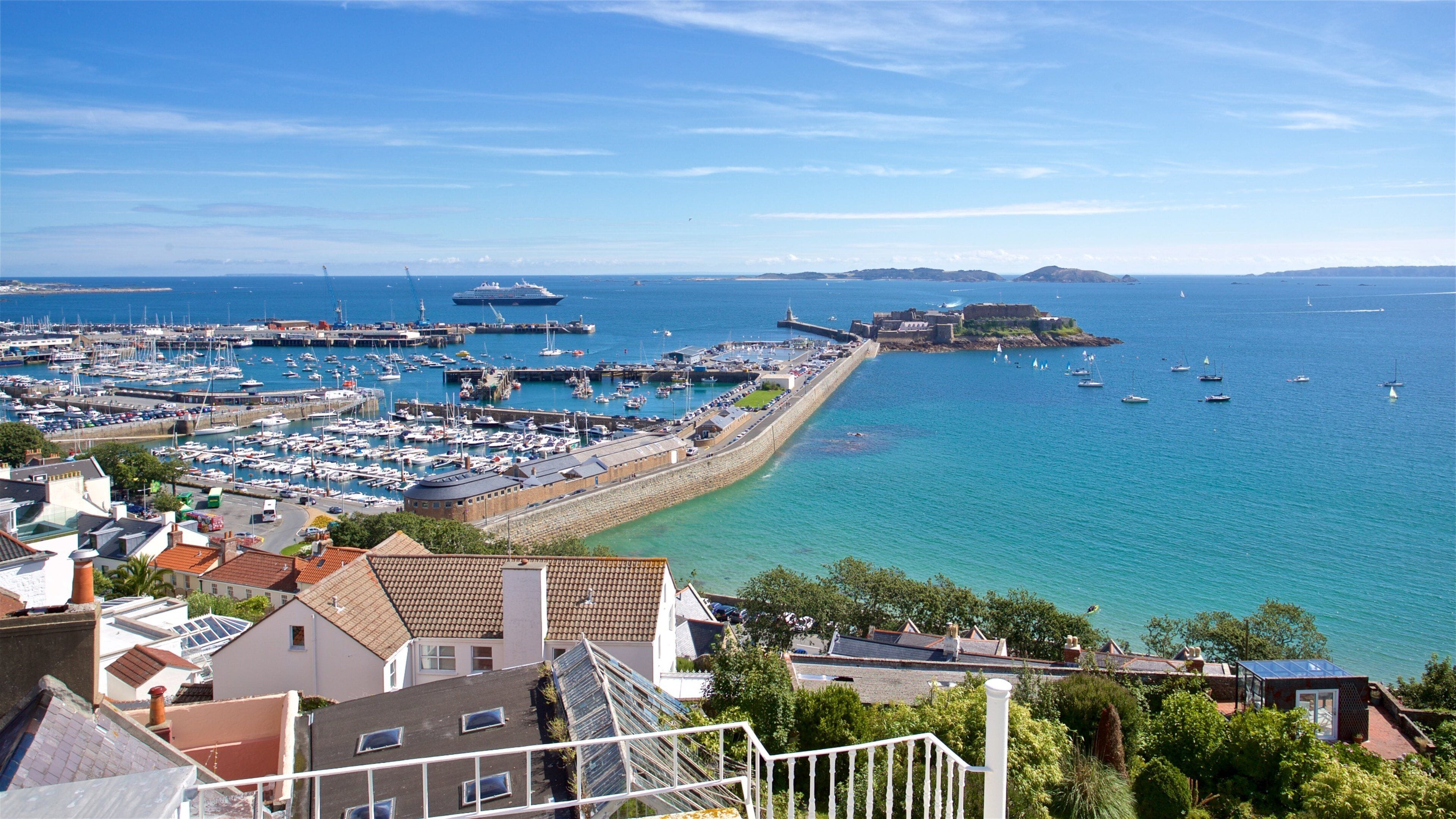 A coastal town with a marina, harbor, and a prominent lighthouse.
