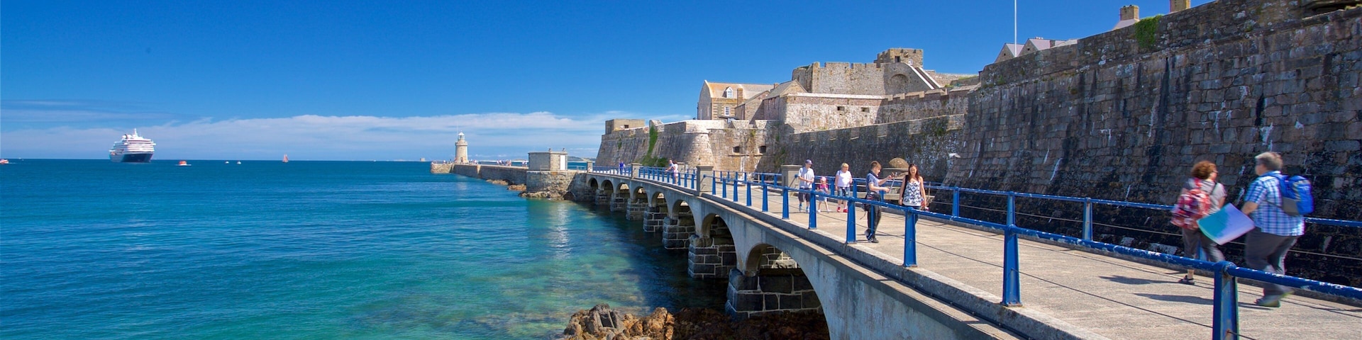 Castle Cornet which includes a bridge and general coastal views as well as a small group of people
