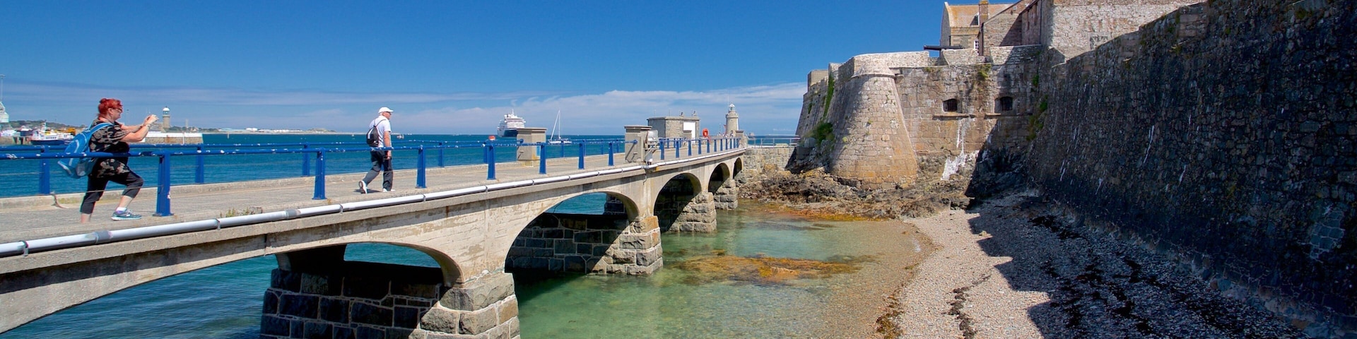Castle Cornet featuring heritage elements, a bridge and general coastal views