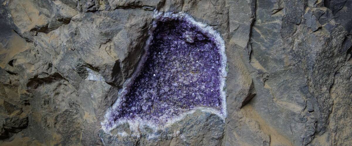 A purple mineral deposit on a rocky surface.
