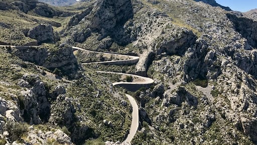 The Serra de tramuntana mountain range in northern Mallorca. A serpentine road cuts through the mountain. It is a drive that should not be missed!
