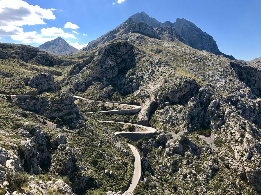 The Serra de tramuntana mountain range in northern Mallorca. A serpentine road cuts through the mountain. It is a drive that should not be missed!