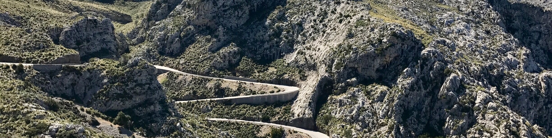 The Serra de tramuntana mountain range in northern Mallorca. A serpentine road cuts through the mountain. It is a drive that should not be missed!