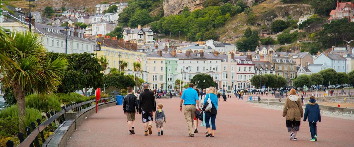 Promenade featuring a small town or village as well as a small group of people