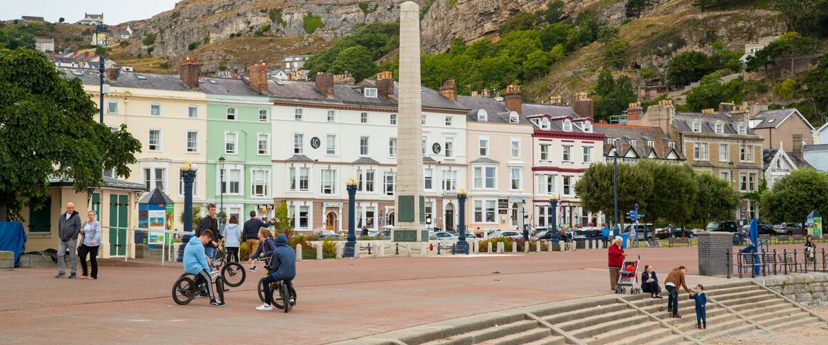 Promenade which includes a small town or village as well as a small group of people