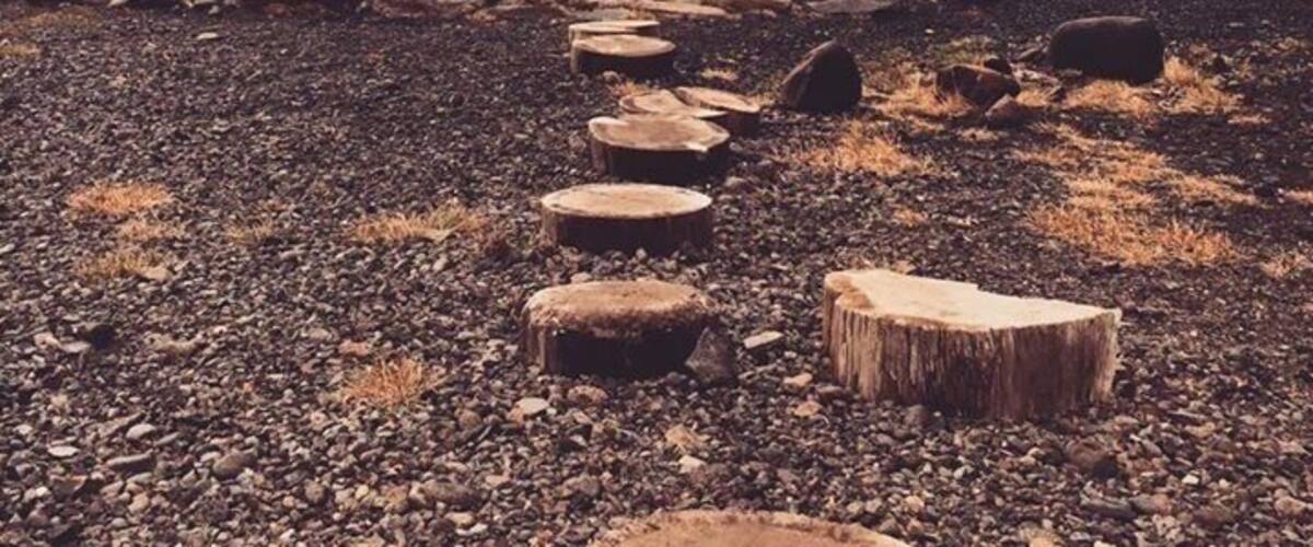 A natural hot spring surrounded by rocks and pebbles.