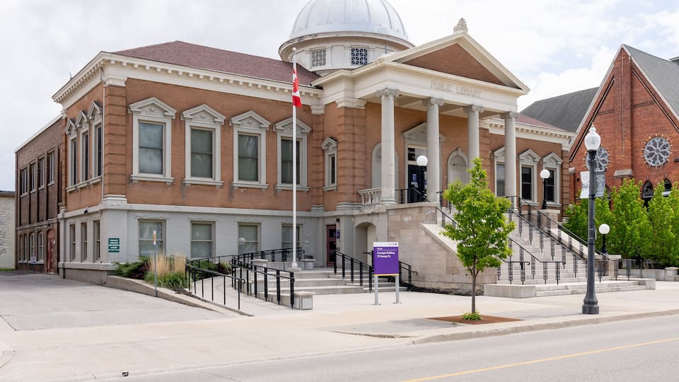 A historic library building with a dome, columns, and a staircase leading to the entrance.