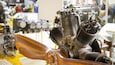 A detailed engine with visible components and a wooden propeller.