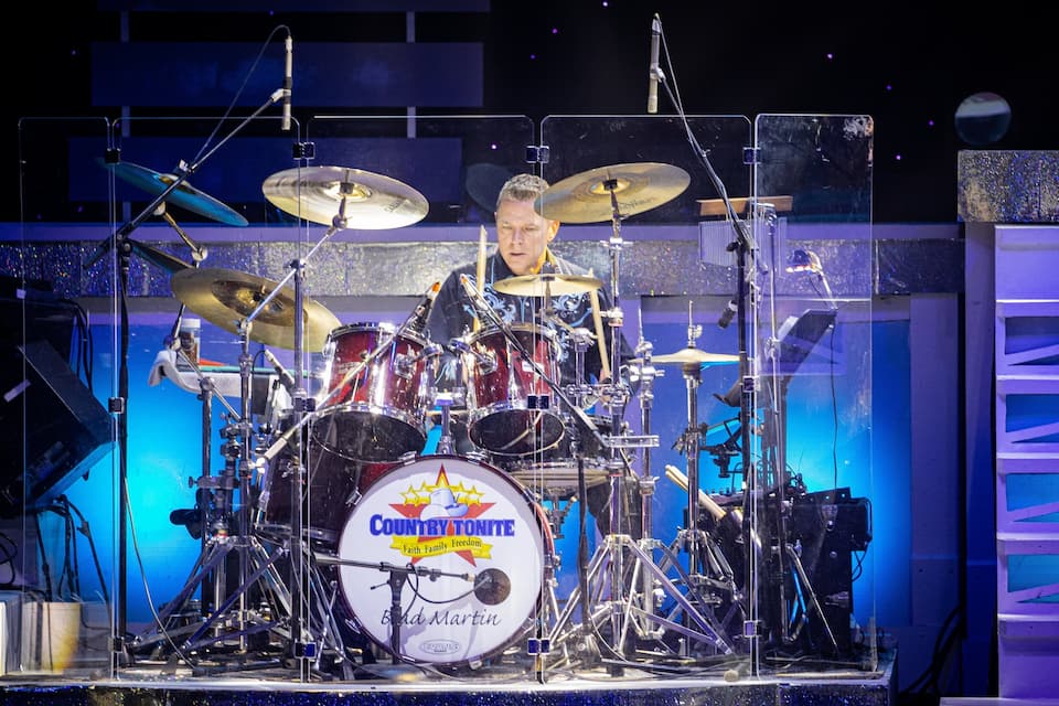 A drum set with a logo that reads "Country Tonite Faith Family Freedom."