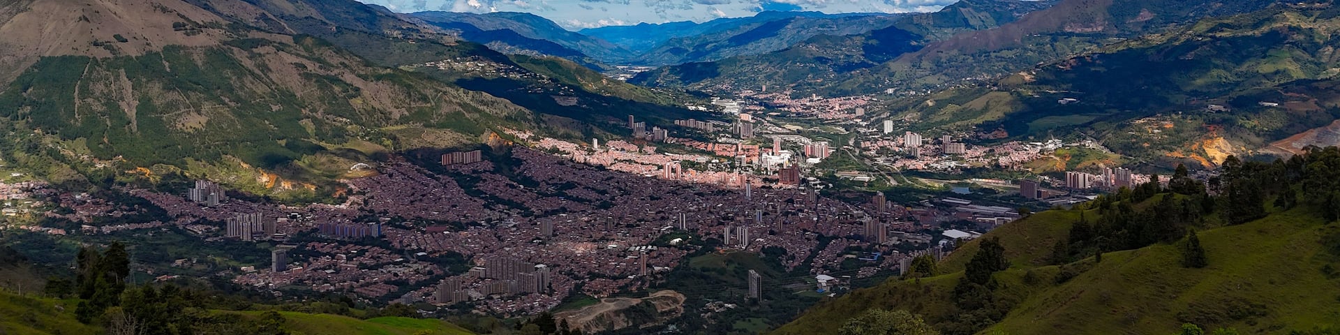 A mountainous landscape with a city nestled in the valley.