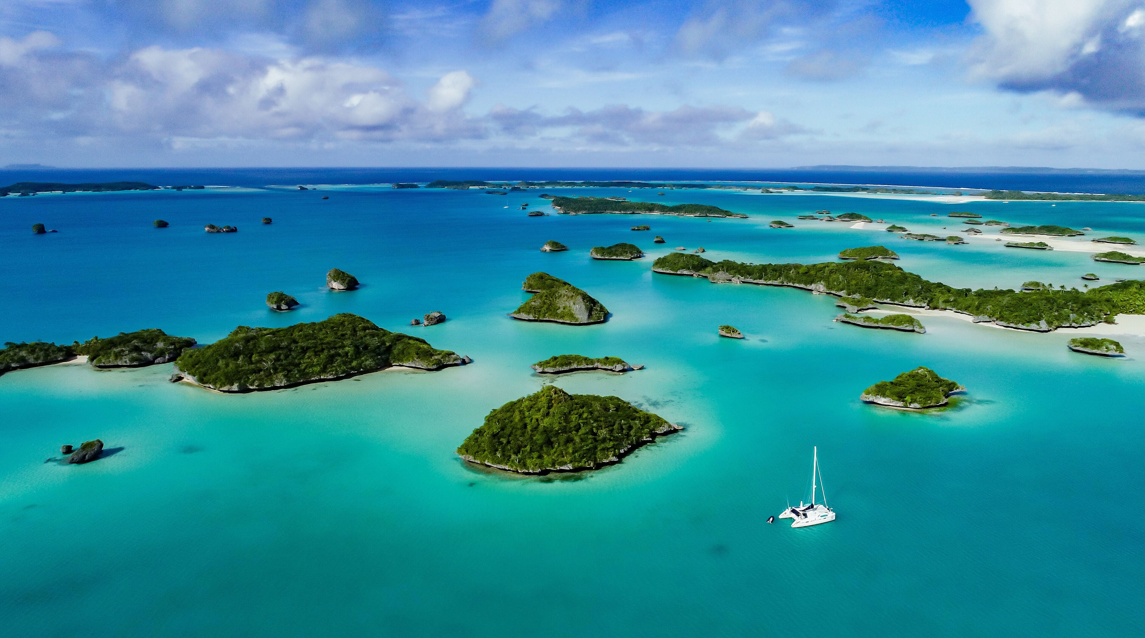 A spectacular  drone  image over Falaga Island in the lower Lau Group, Fiji showing a catamaran peacefully at anchor.