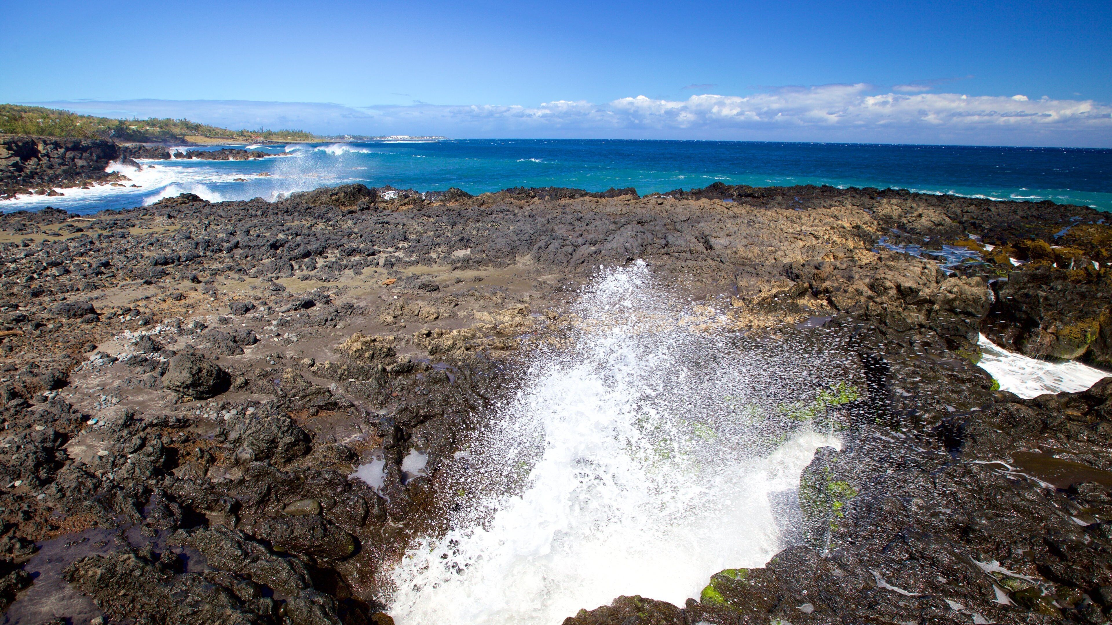 A rocky coastline with waves crashing against the rocks.