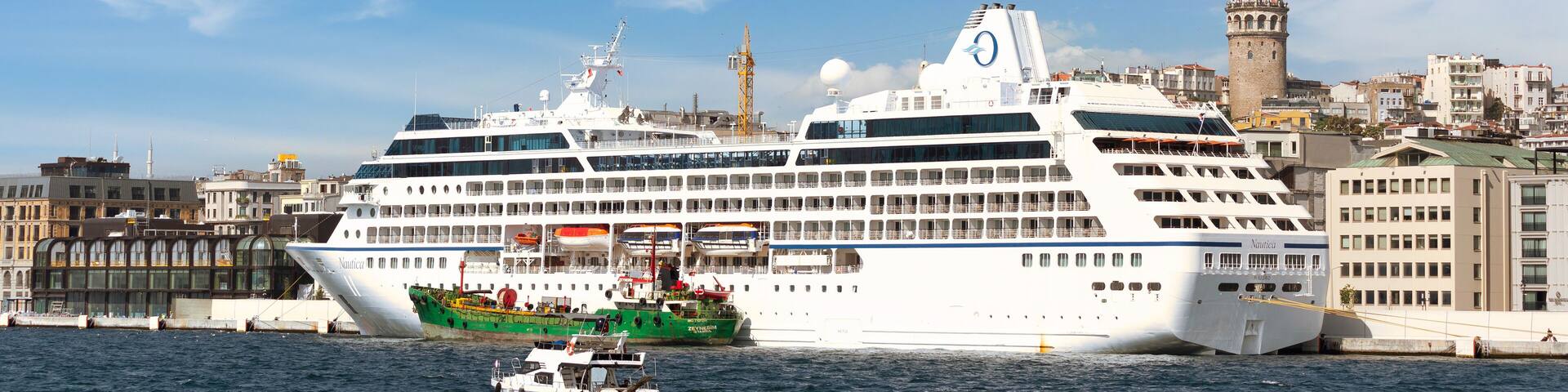Nautica Majuro, Huge cruise ship docked at terminal of Galataport, a mixed use development located along the Bosphorus, in Karakoy neighbourhood, with Galata tower in the far end, Istanbul, Turkey