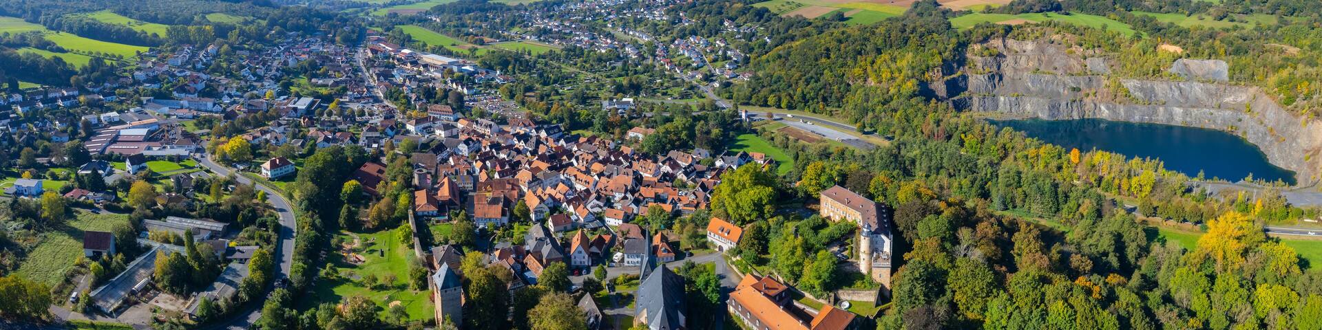 Aerial panorama view around the city Ortenberg
in Germany. on a sunny noon in fall.