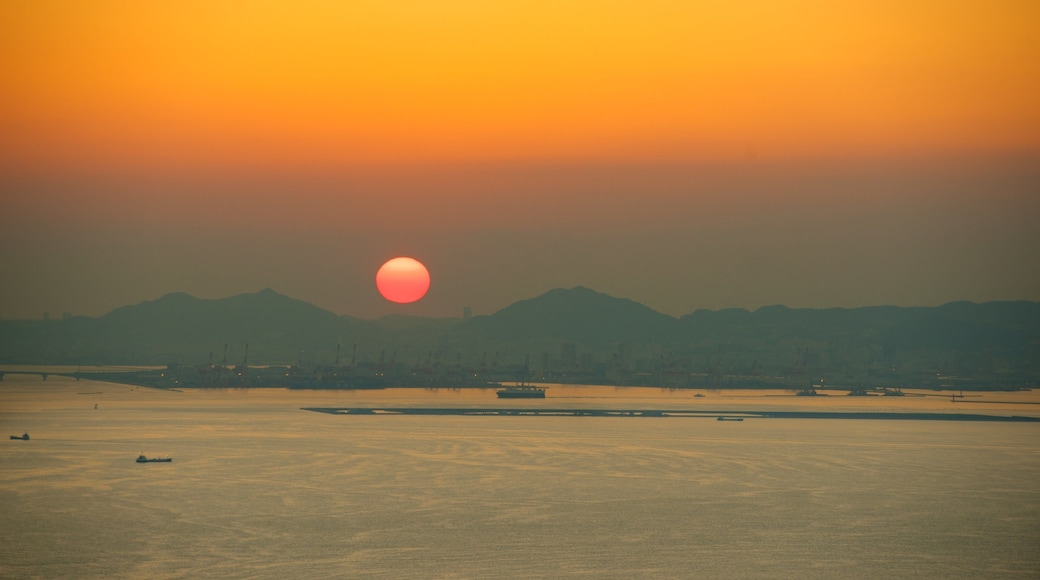 Osaka Prefectural Government Sakishima Building which includes a sunset and a bay or harbour