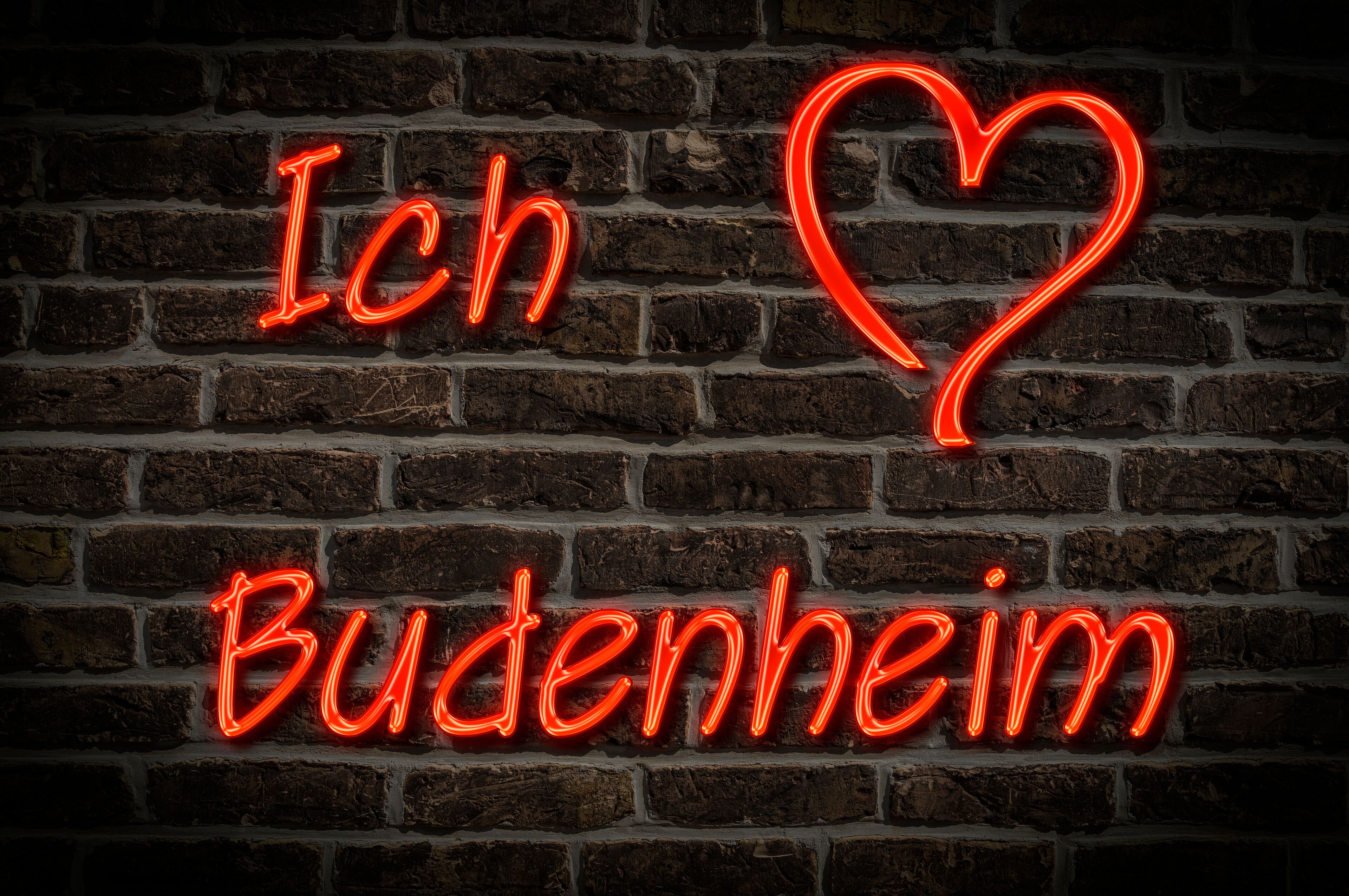 A neon sign on a brick wall with the text "Ich Buchenheim" and a heart symbol.