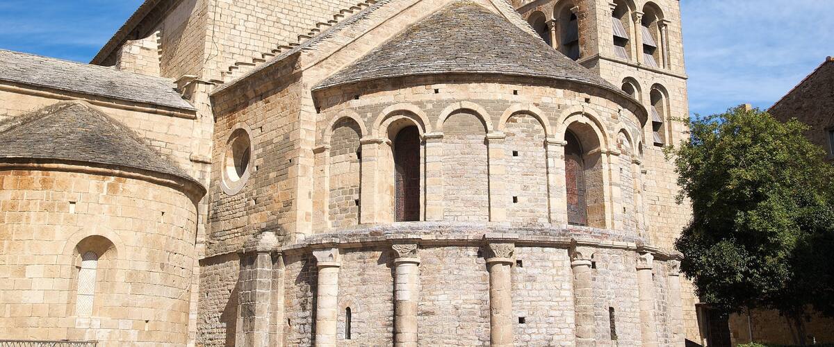A historic stone church with a bell tower and arched windows.