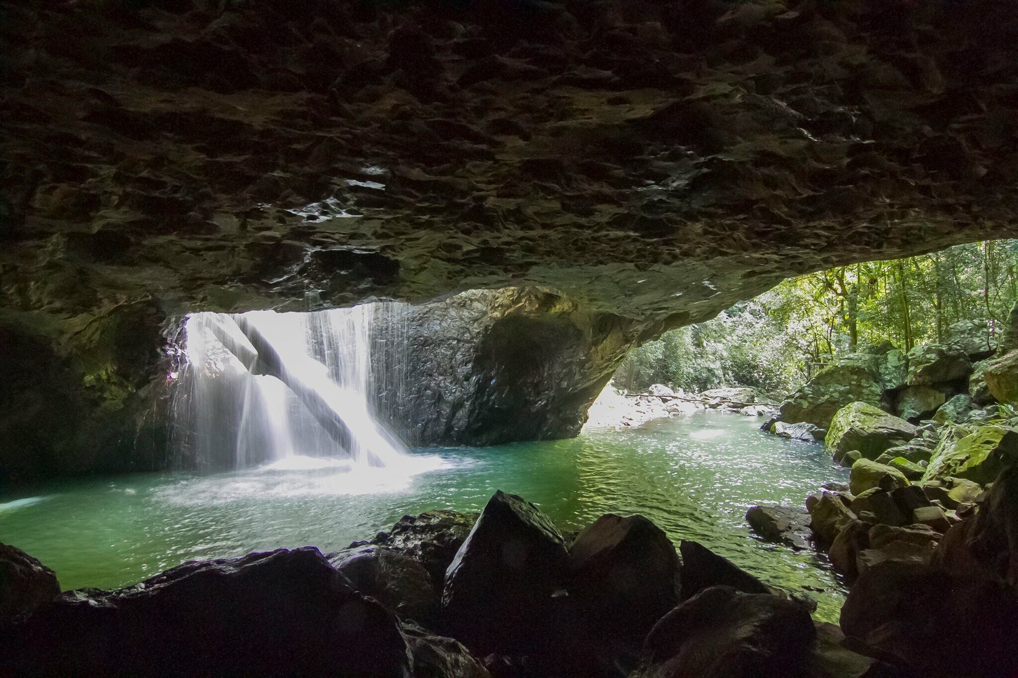 The beautiful cave in which the river above bore a hole through the rock to create this spectacular scene with the water cascading through the hole into the cave, was a popular swimming spot for locals 20yrs ago though it's now been banned. The cave is also home to glow worms which glow in the dark.