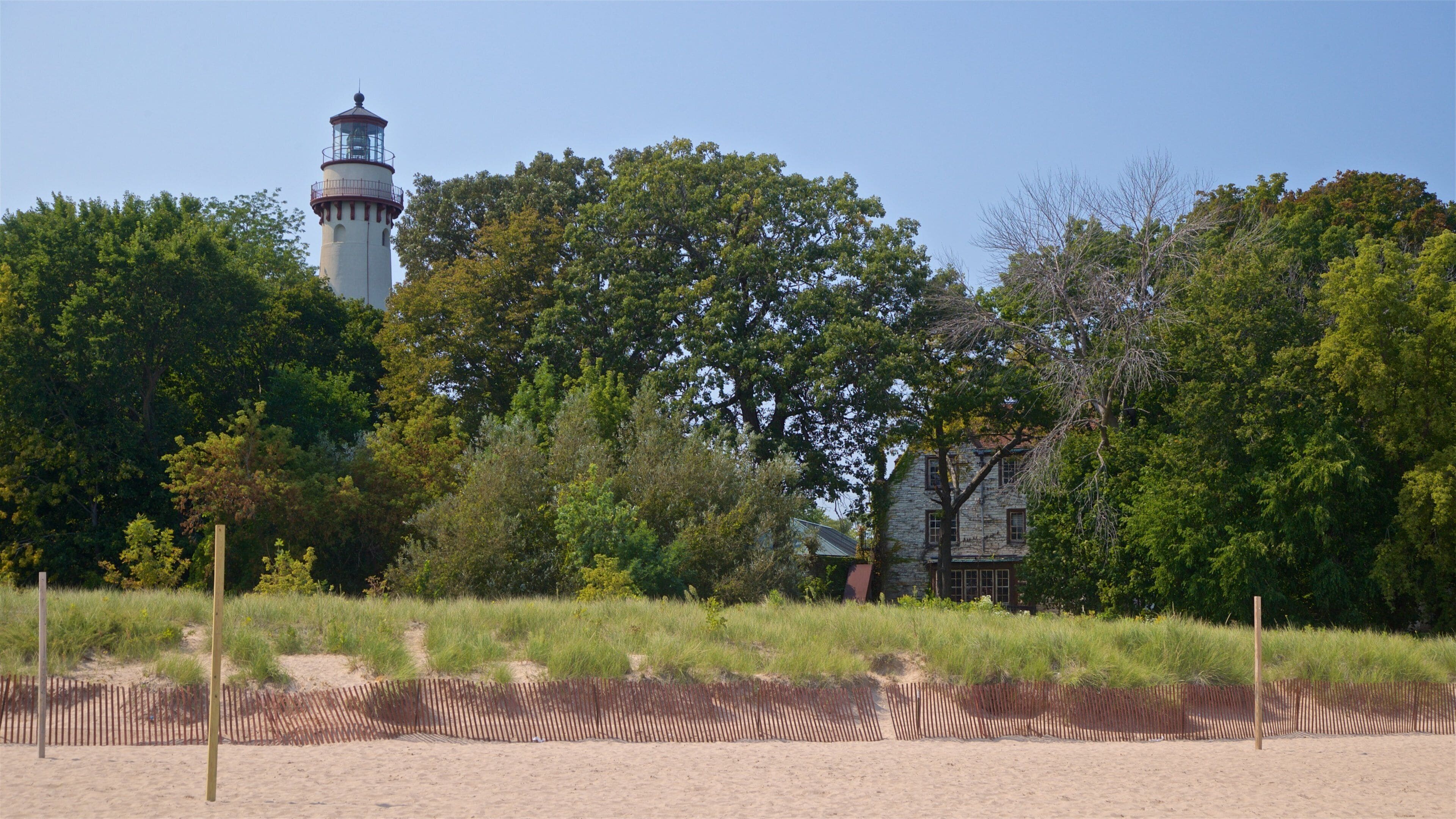 Grosse Point Lighthouse featuring a lighthouse and a sandy beach
