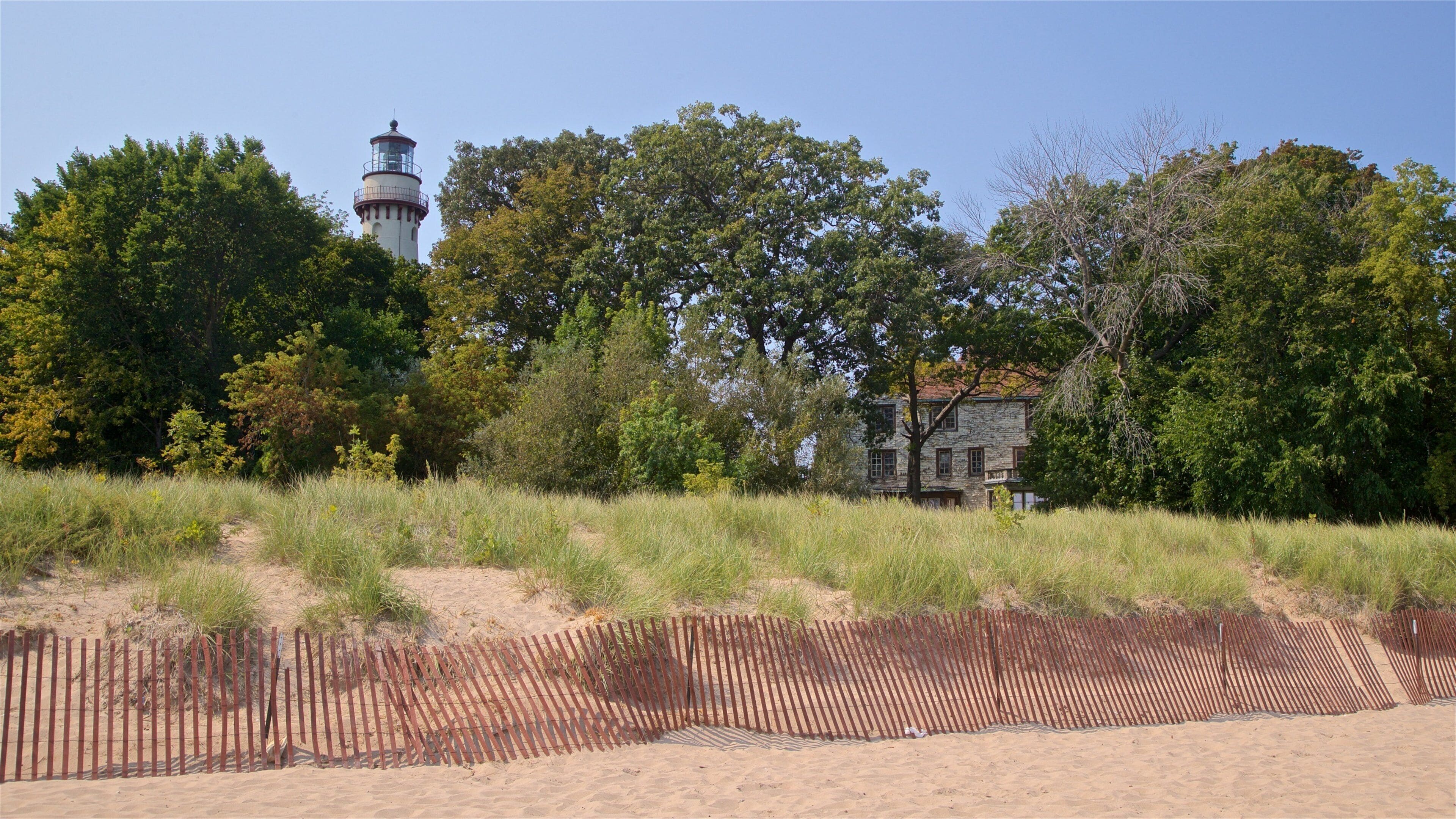 Grosse Point Lighthouse featuring a sandy beach and general coastal views