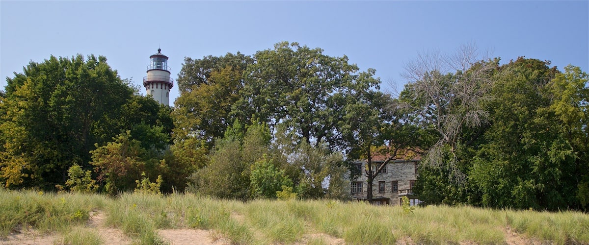 Grosse Point Lighthouse which includes general coastal views and a sandy beach