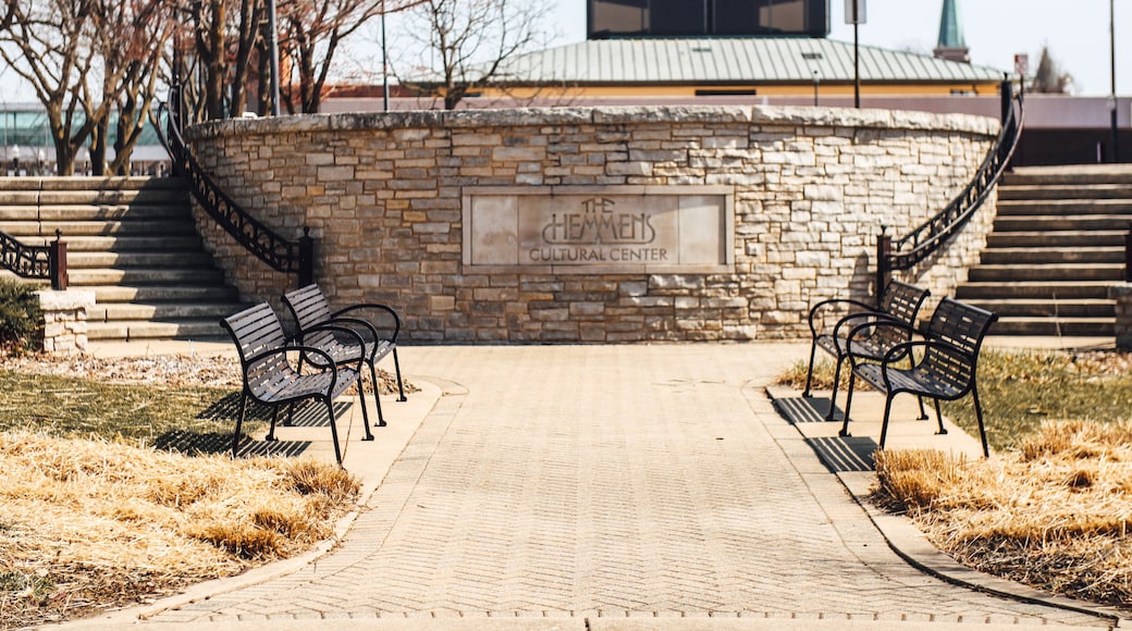 Outdoor park of The Hemmens Cultural Center with metal benches and sidewalk stairways