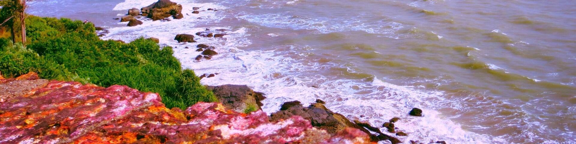 View of the lovely coastline from the Bekal Fort. The waves hit the rocky patches on the beach splashing water on the Fort walls. The sea looks calm now.
