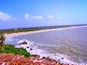 View of the lovely coastline from the Bekal Fort. The waves hit the rocky patches on the beach splashing water on the Fort walls. The sea looks calm now.