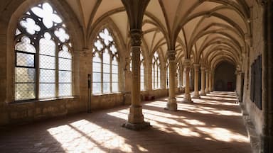 A cathedral interior with arched windows and columns.