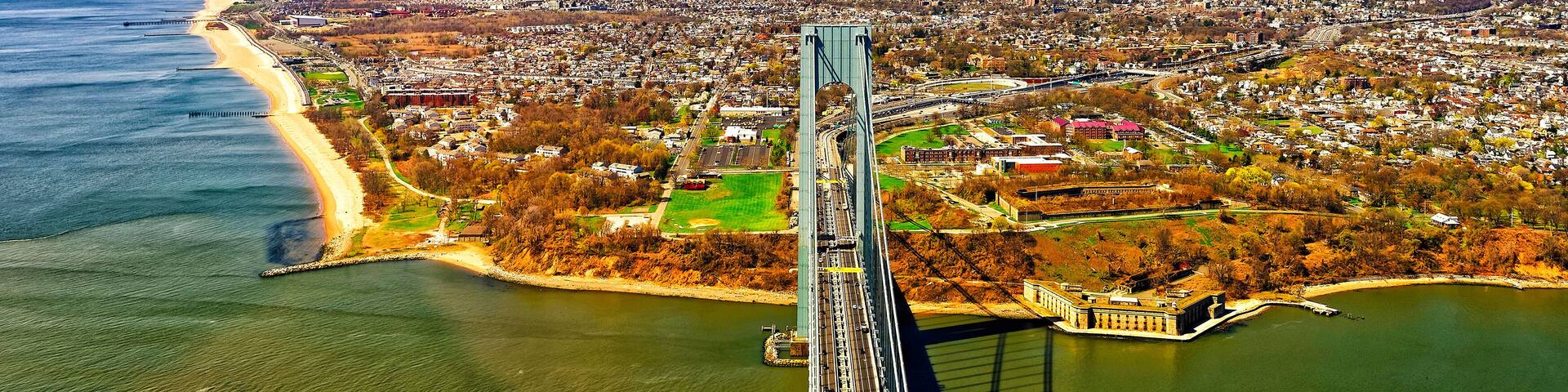 A bridge spanning a river with a cityscape in the background.