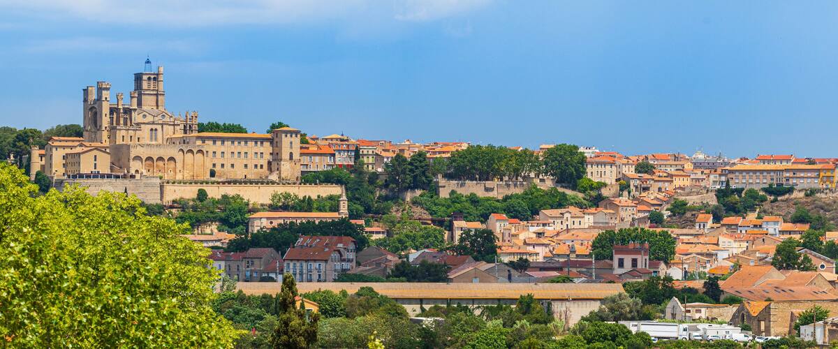 A historic cityscape with a prominent cathedral and surrounding residential buildings.