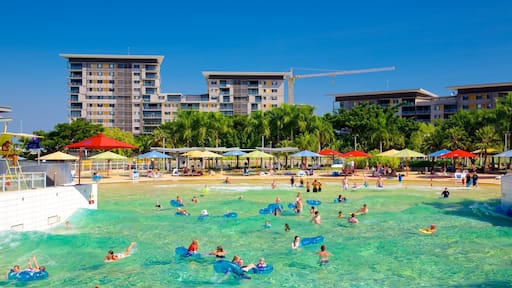 Darwin Waterfront which includes a pool and swimming as well as a large group of people