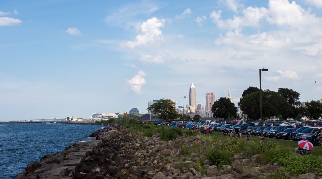 Lake Erie, Cleveland, Ohio/ USA - 3 September 2018: People relax on the beach, tall skyscrapers are visible in the distance. Cleveland skyline