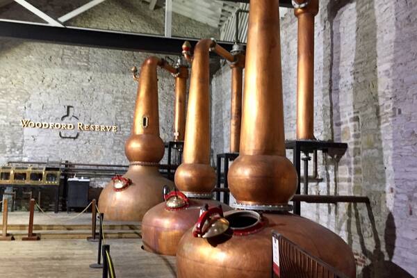The triple
Copper distillation stills at Woodford Reserve. They are the only distillery to use three stills in the process of making bourbon.