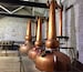 The triple
Copper distillation stills at Woodford Reserve. They are the only distillery to use three stills in the process of making bourbon.