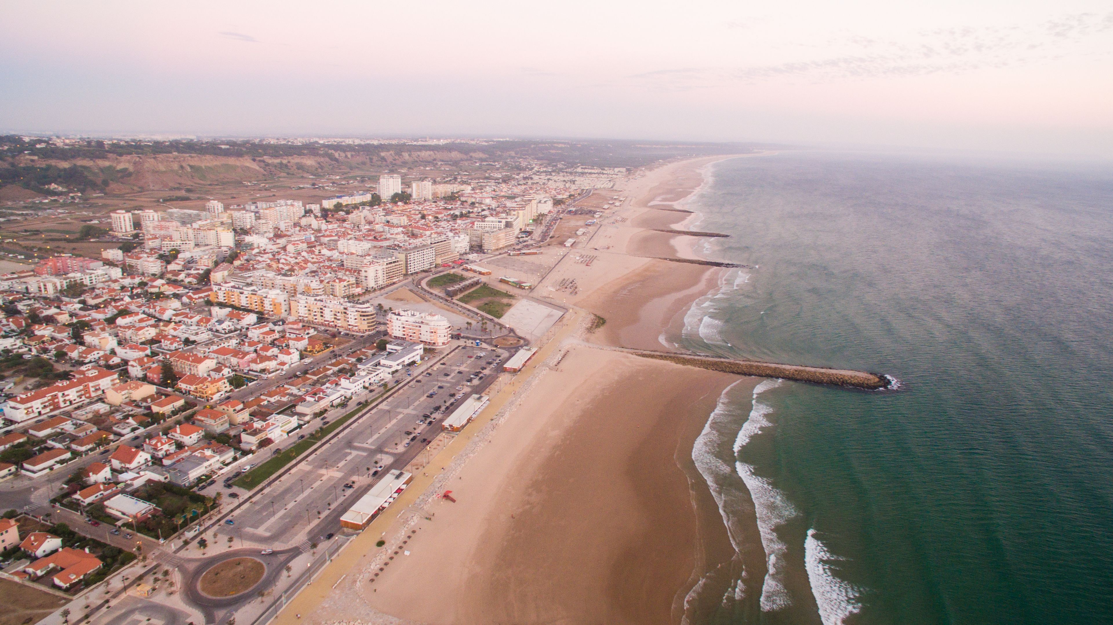 Panorama of Costa Caparica beach at evening aerial view