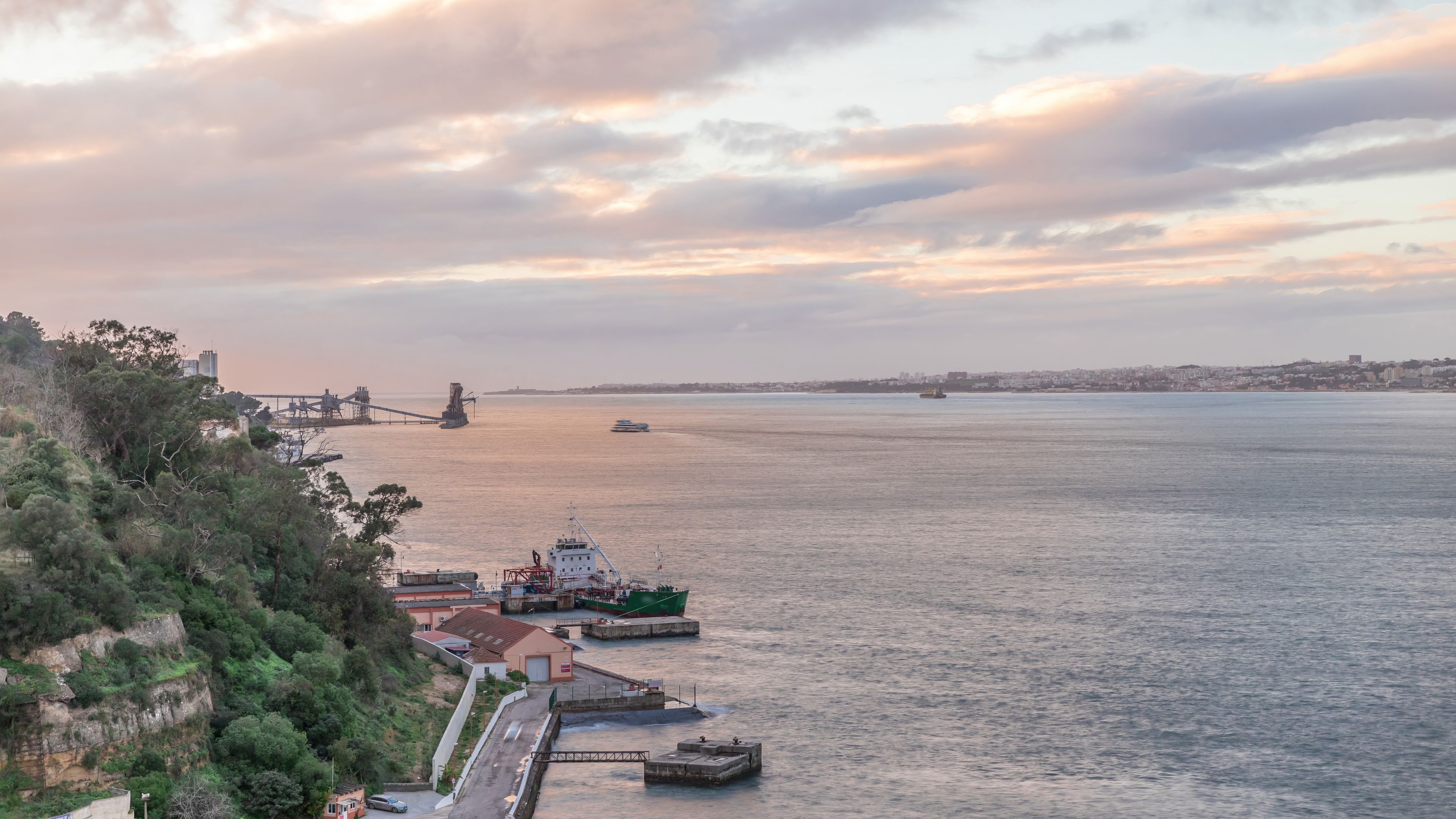 Aerial timelapse from a hill near Porto Brandao Ferry Station on the Tagus River in Lisbon