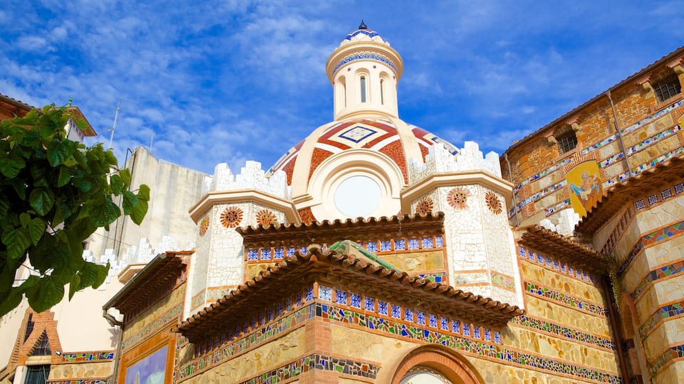 A colorful building with a tiled dome and intricate mosaic work.